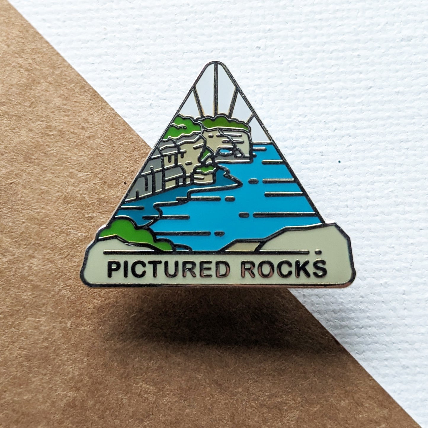 Triangle Pictured Rocks national lakeshore enamel pin featuring a view from Grand Portal Point.