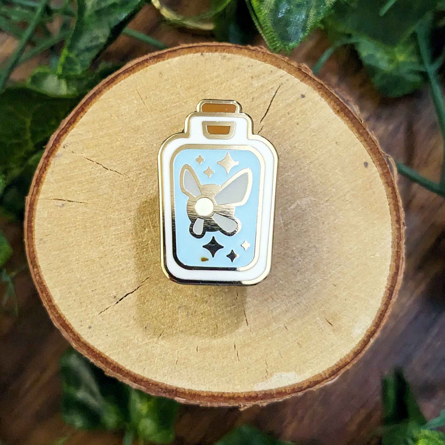 Glow in the dark blue fairy in a rectangular bottle enamel pins.
