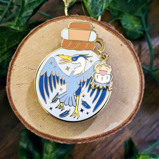 Flying blue heron with falling feathers bottled guardian enamel pin