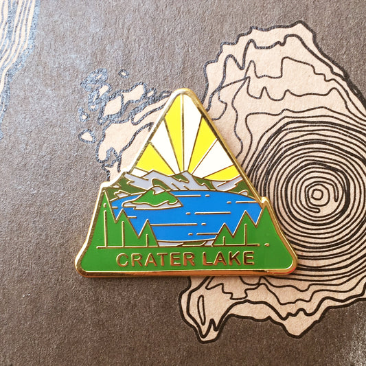 Triangle Crater Lake national park enamel pin featuring a view of Wizard Island.