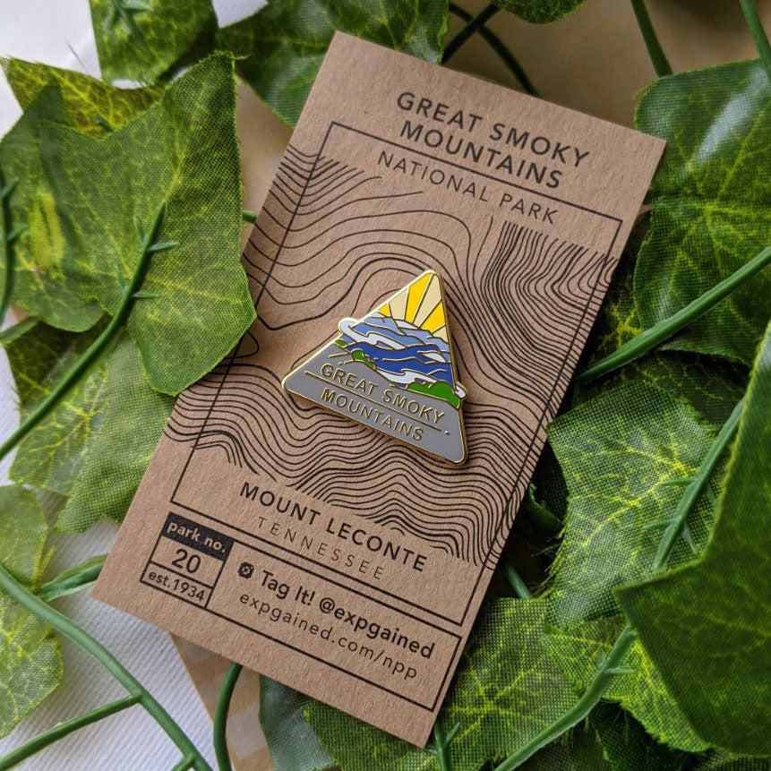Triangle Great Smoky Mountains national park enamel pin featuring a view from the beehive hike on a brown business card size backing card with a topo map of Mount LeConte.