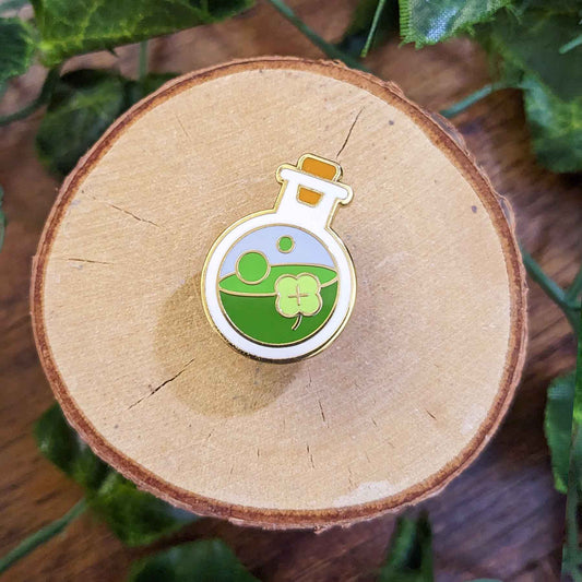 Green luck potion in a bottle with clover enamel pin