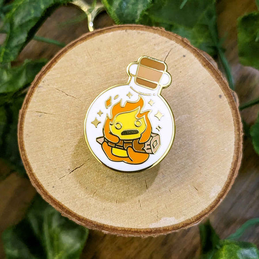 Hanging orange and yellow fire demon flame on a wood log in a potion bottle enamel pin designed by EXP Gained