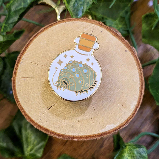 Mysterious friendly gray bug with blue eyes waving a tentacle in a bottle enamel pin designed by EXP Gained