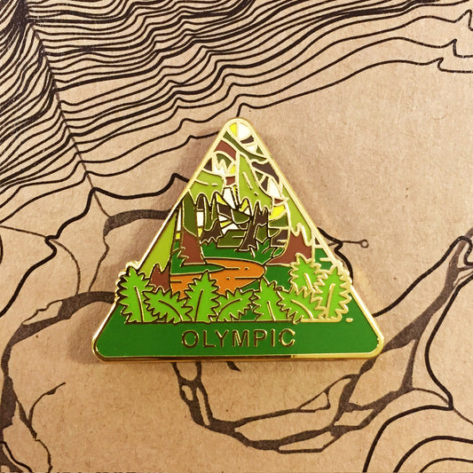 Triangle Olympic national park enamel pin featuring a view of ferns and the Hoh Rainforest.