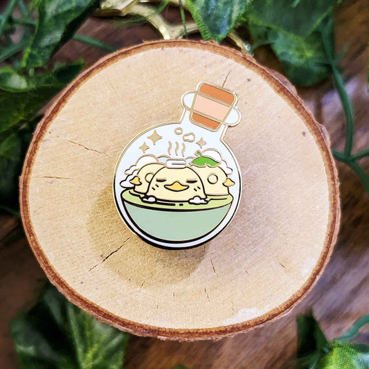 Three relaxing yellow ducks in a hot bath in a potion bottle enamel pin designed by EXP Gained