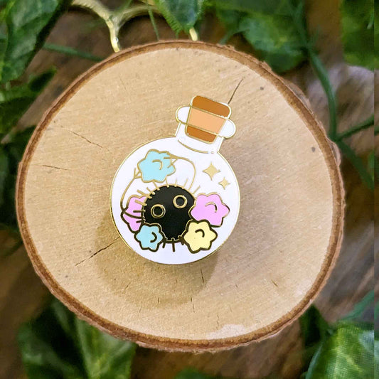 Happy soot spirit with pastel konpeito candy in a potion bottle enamel pin designed by EXP Gained