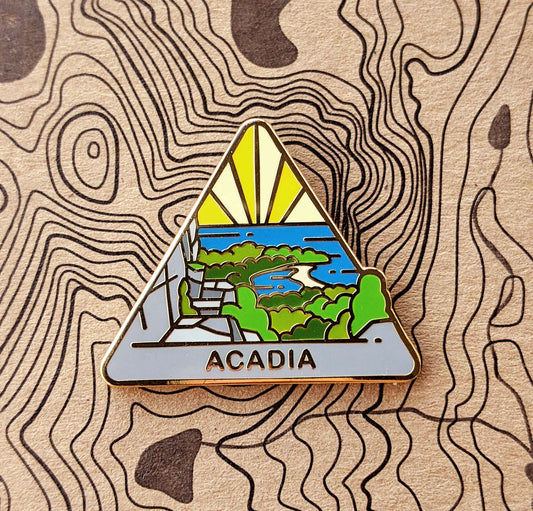 Triangle Acadia national park enamel pin featuring a view from the beehive hike.