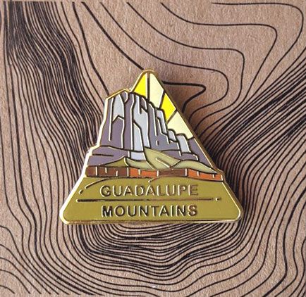 Triangle Guadalupe Mountains national park enamel pin featuring a view of El Capitan.