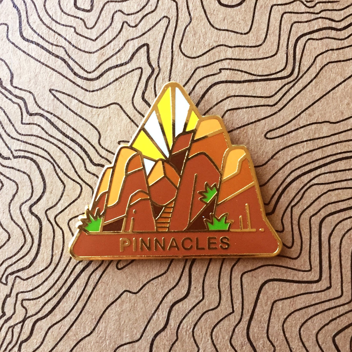 Triangle PInnacles national park enamel pin featuring a view of tall pinnacle spires.