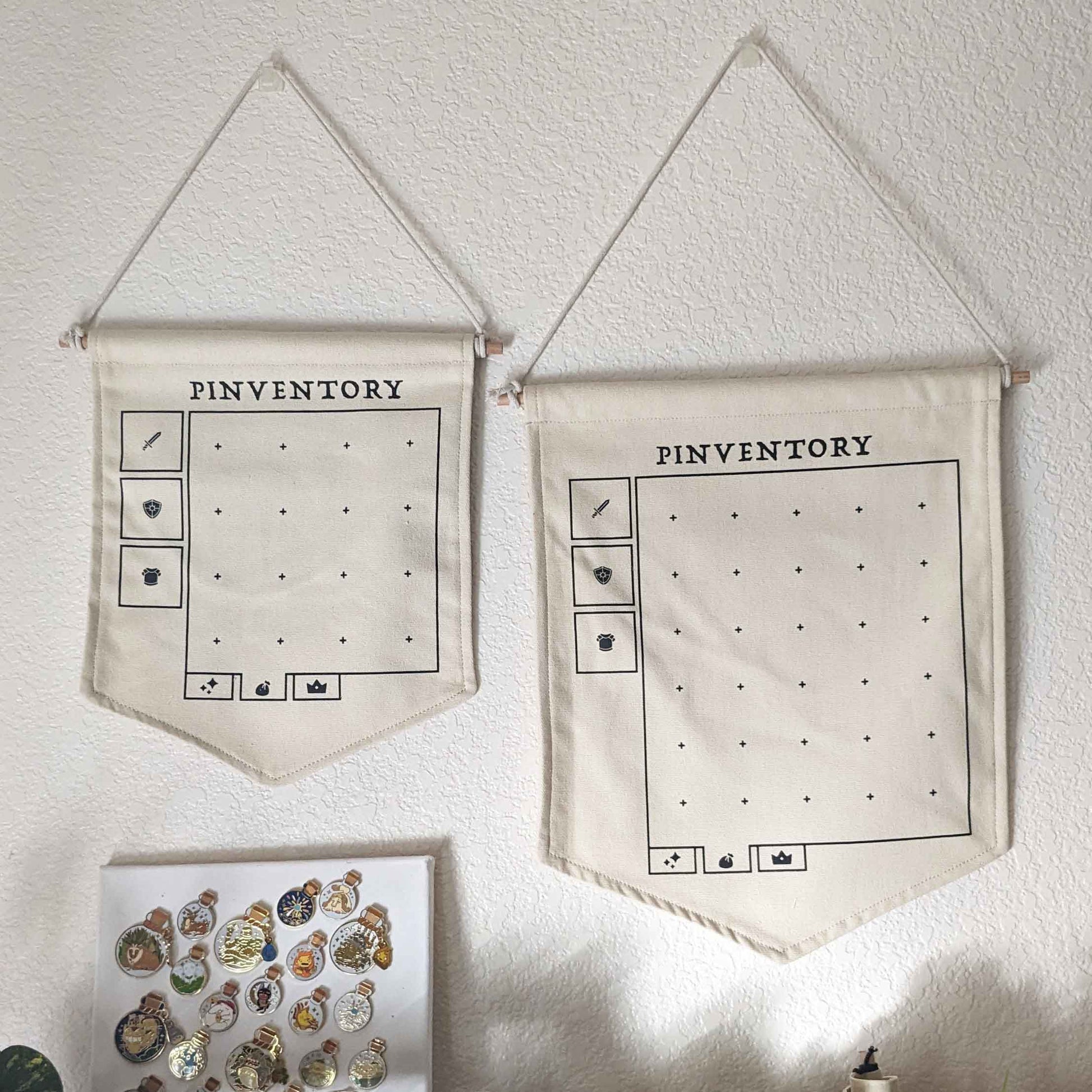 Two canvas pinventory pin banners hanging on a white wall 