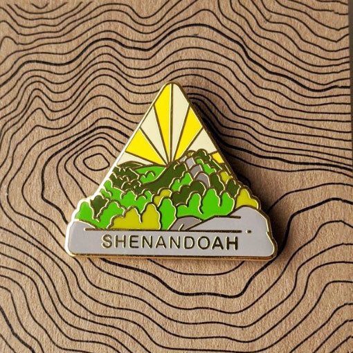 Triangle Shenandoah national park enamel pin featuring a view of stretching forest from the top of Old Rag Mountain..